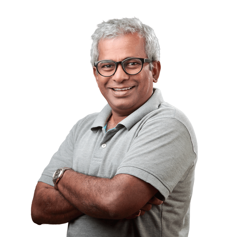 Smiling man wearing glasses and a grey tshirt with his arms crossed