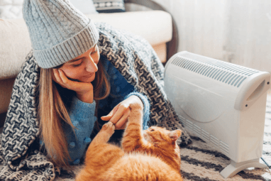 Image of a woman next to a heater